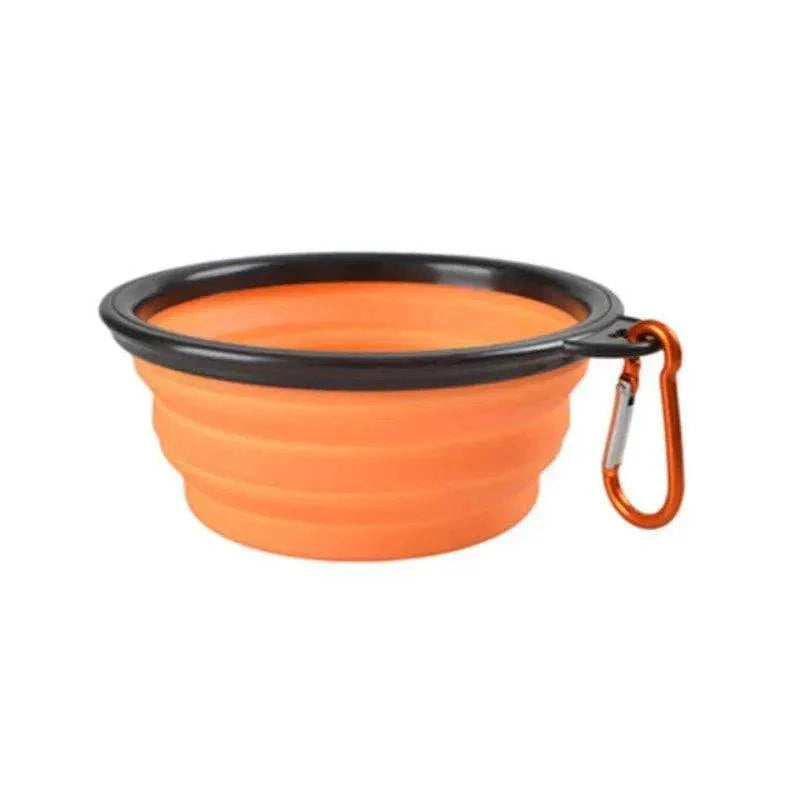 Portable silicone travel bowl for pet food and water, collapsible and lightweight with carabiner for easy carrying.