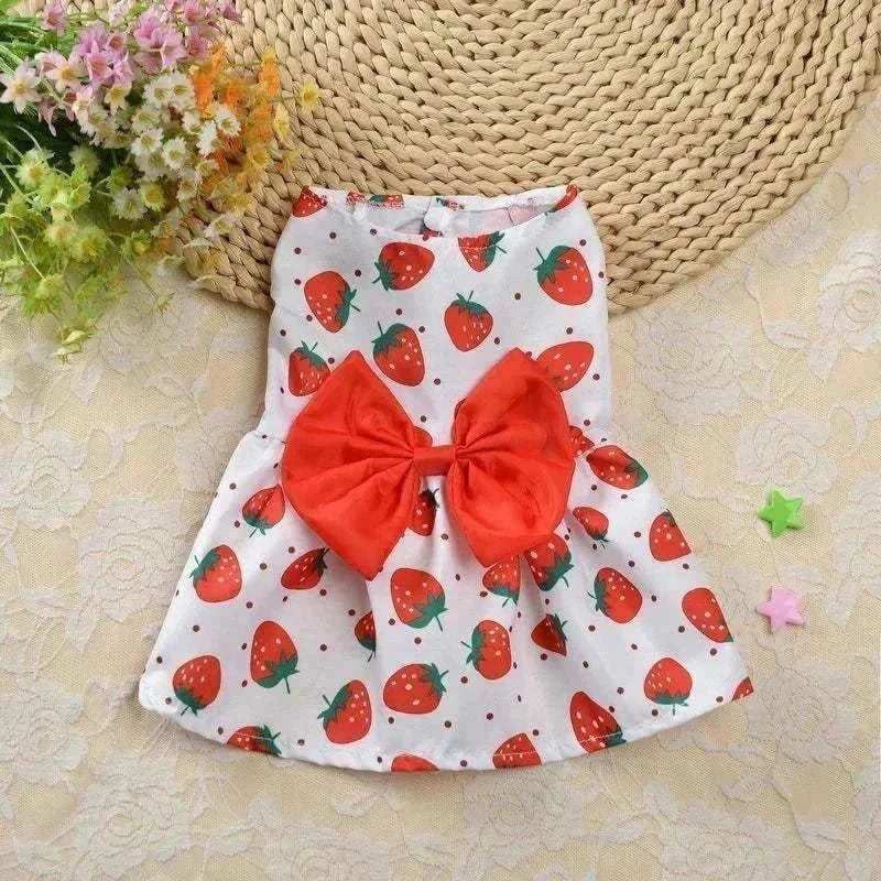 Floral princess-style pet dress for small dogs and cats, with strawberry pattern and red bow, perfect for summer wear.