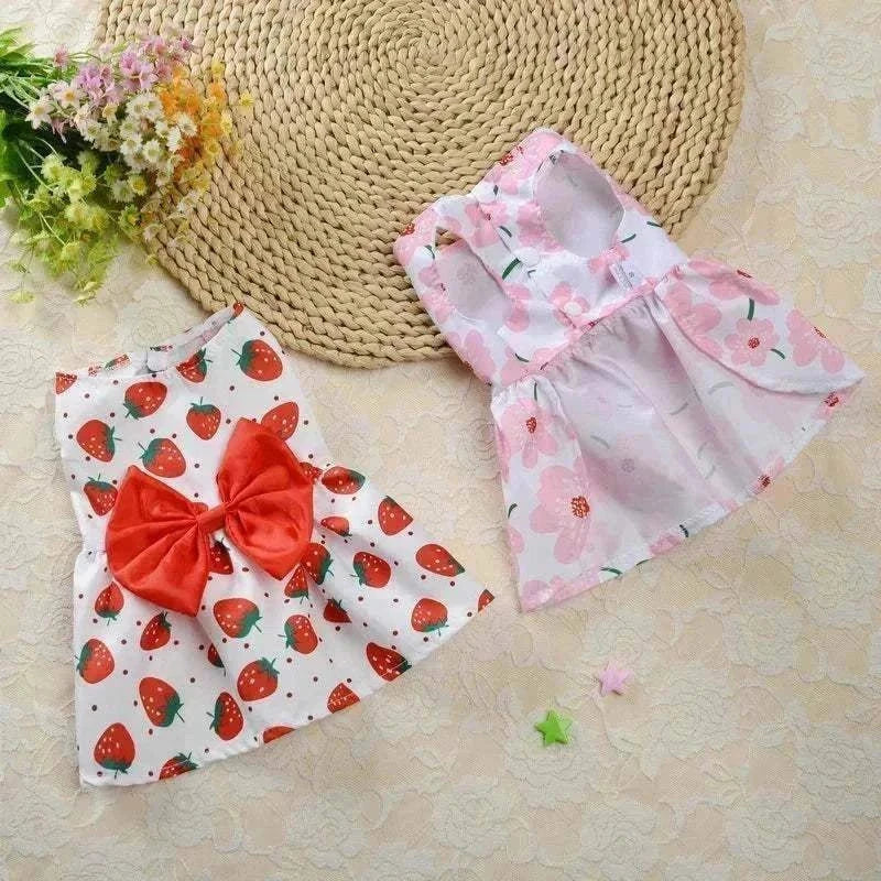 Floral princess-style dresses for small dogs and cats with strawberry and pink flower patterns.
