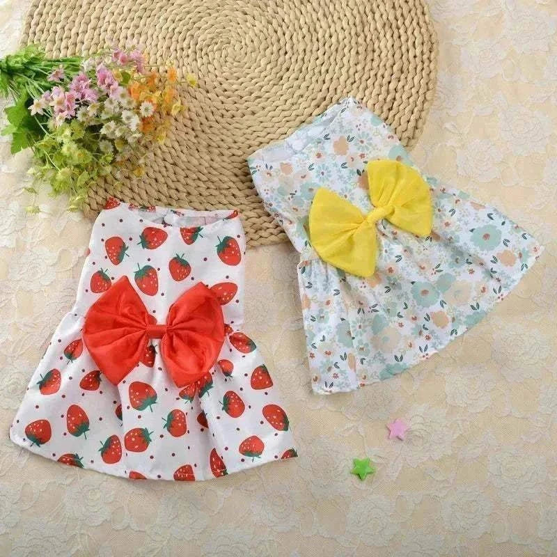 Floral princess-style summer dresses for small dogs and cats with strawberry and flower patterns, featuring colorful bows.
