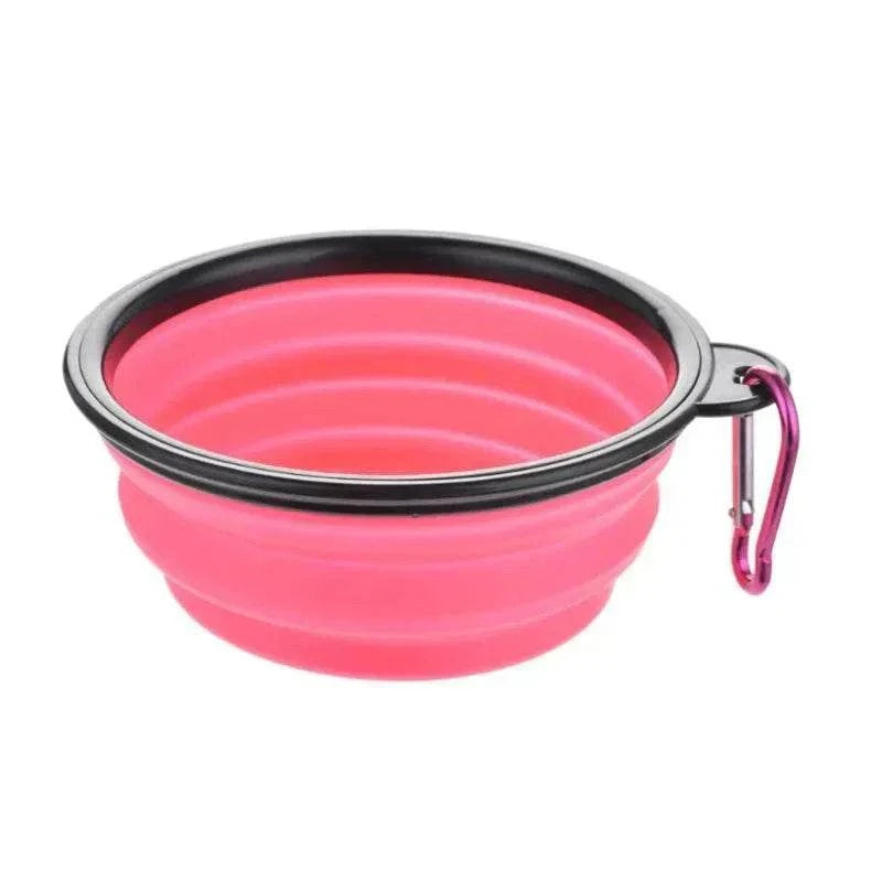 Collapsible pink silicone pet travel bowl with carabiner for dogs and cats.